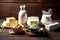 Bottle and jug with milk bowl with cottage cheese and dairy product on wooden table