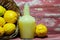 Bottle of lemon juice and fruits in wooden basket