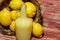 Bottle of lemon juice and fruits in wooden basket