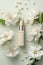 A bottle of lipstick surrounded by white flowers.