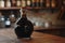 A bottle of liquor is placed prominently on top of a sturdy wooden table, Bottle of 100-year-old balsamic vinegar, AI Generated