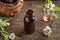 A bottle of marshmallow root tincture with Althaea officinalis flowers