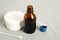 Bottle of medical iodine, cotton pads and buds on grey table