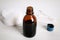 Bottle of medical iodine, cotton pads and buds on white wooden table, closeup