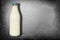 Bottle Of Milk With Blue Lid Isolated On Dark Slate - Unopened