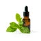 bottle with mint essential oil and green leaf on white background