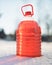 Bottle with non-freezing windshield washer fluid, snow background