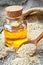 Bottle of oil sesame seeds in sack on old wooden table