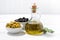 Bottle with olive oil and bowls with olives