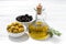 Bottle with olive oil and bowls with olives, closeup