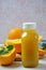 Bottle of orange juice studio shot orange organic freshly squeezed juice in a small plastic bottle on a colorful