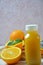 Bottle of orange juice studio shot orange organic freshly squeezed juice in a small plastic bottle on a colorful