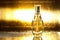 Bottle of perfume on gold background