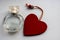 Bottle of perfume with red hearts flying out from it. Valentine`s day, choosing fragrance, pheromones