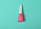 A bottle of pink nail polish on a blue background. Top view. Manicure for nails