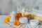 A bottle of pot marigold tincture, ointment, cream with fresh and dry Calendula flowers and cotton pad and sticks on a