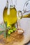 Bottle pouring virgin extra olive oil on a spoon