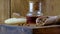 A bottle of propolis tincture and a wooden scoop of propolis granules. Medical preparations bee propolis. Bee glue