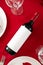 Bottle of red wine mockup on Romantic Valentines Day table dinner setting. Top view