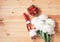 Bottle of rose champagne, fresh strawberry and white peonies on wooden background