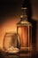 a bottle of rum , golden whiskey or liqueur . a glass of bourbon has a beautiful dark background. elite alcoholic retro