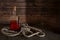 Bottle with rum on a wooden background and a rope