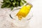 A bottle of Saffron basil seeds drink served in iced cube bowl side view on grey background