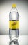 Bottle of Schweppes Indian tonic drink isolated gradient background.