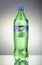 Bottle of Sprite drink on gradient background.