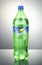 Bottle of Sprite drink on gradient background.