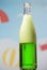 Bottle with tarragon carbonated drink on summer background