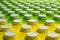 Bottle tops on green and yellow surface