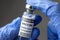 Bottle of vaccine for COVID-19 coronavirus in doctor gloved hands close-up
