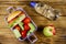 Bottle of water, apple and lunch box with burgers and fresh vegetables on wooden table. Top view