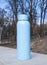 Bottle for water. Blue capacity. Sport equipment. Outside. Jogging