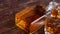 Bottle of whiskey with two glasses placed on rustic wooden table