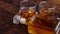 Bottle of whiskey with two glasses placed on rustic wooden table