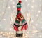 Bottle of wine in a christmas woolen scarf and hat