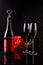 Bottle of wine with a cork in the form of heart and two glasses of three red gerbera