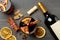 Bottle of wine, cups of mulled wine and ingredients on wooden background