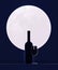 A bottle of wine and a glass of wine against the backdrop of a big moon