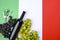 A bottle of wine, grapes, and the flag of Italy close-up. Country symbol backdrop. The concept of harvesting, august