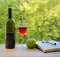 Bottle of wine green apple eyeglasses and book on table