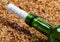 Bottle of wine with help message on sand in beach at sun summer