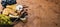 A bottle of wine, and a large assortment of cheeses, honey, nuts and spices, on a wooden table. Top view.