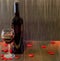 Bottle of wine with transparent glass with red wine, textile red hearts, wood texture background, close up