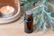 A bottle of wormwood essential oil with fresh Artemisia Absinthium and a candle