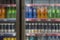 Bottled drinks in the refrigerator in the store. Blurred. Front view