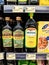 Bottled olive oil stands on the shelf in the supermarket