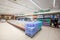 Bottled water department, shelves with various plastic bottles of natural and effervescent mineral water